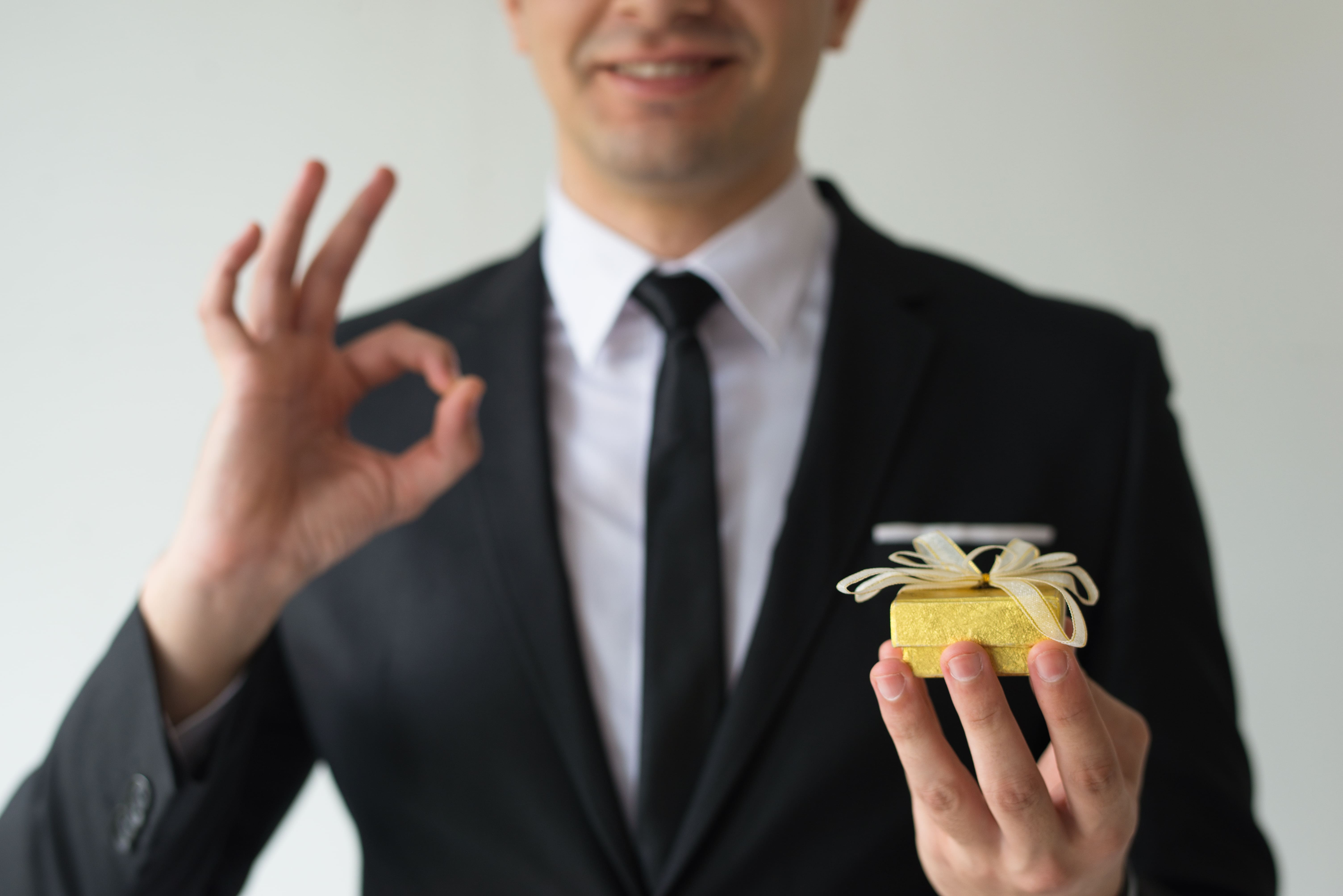 close-up-happy-businessman-holding-small-gift-box (1).jpg